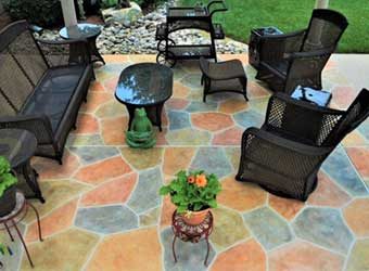 table and chairs and plants on the concrete floor