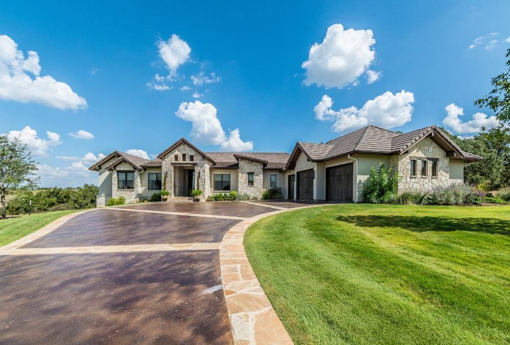 house with a concrete driveway and a lawn