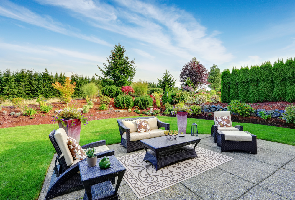 outdoor patio and green plants at the back with modern chair set