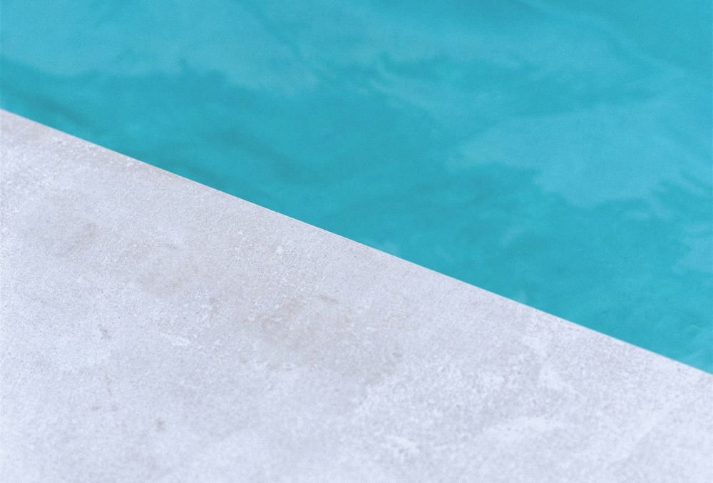 white overlay on concrete pool deck