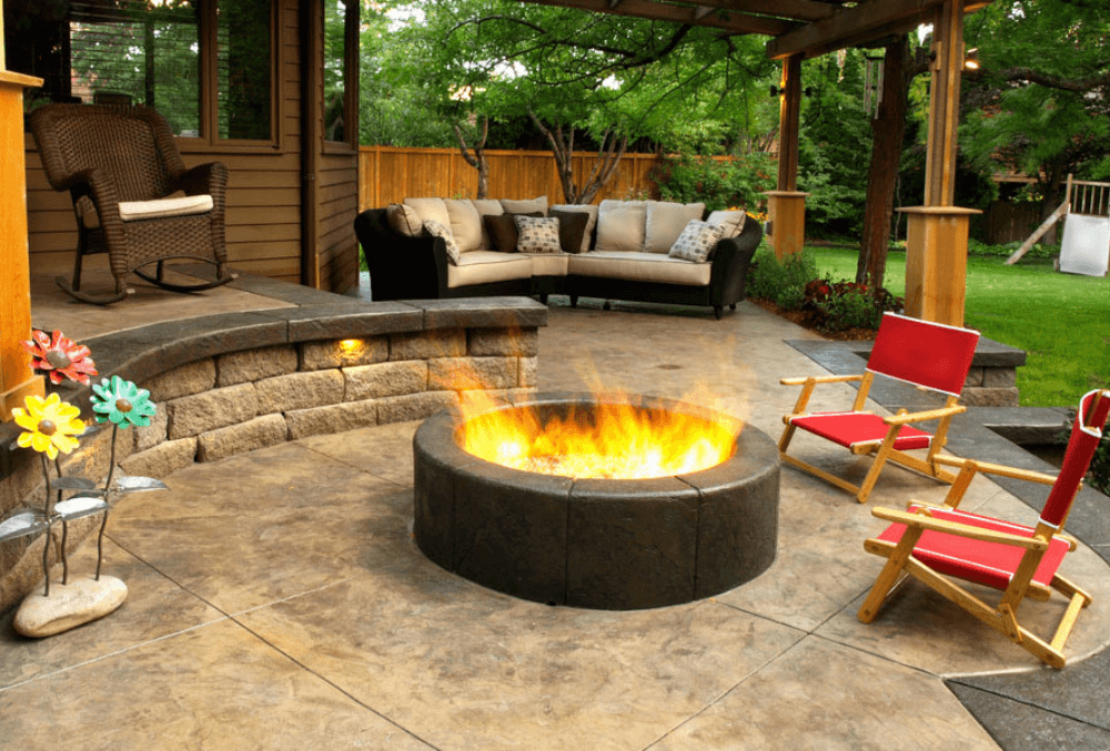 fireplace with chair on stamped colored concrete patio