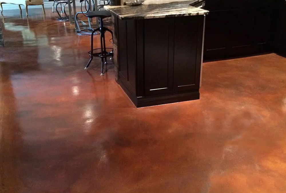 Glossy stained concrete floor with dark cabinets