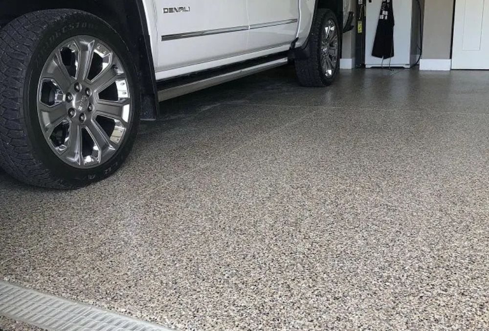 Epoxy garage floor beneath parked vehicle
