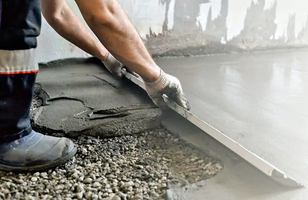 contrator holding a scalper for concrete flooring atlanta