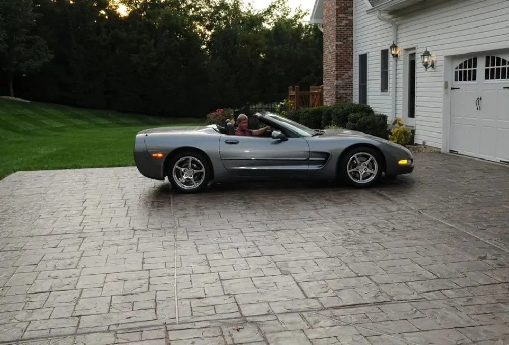 Silver convertible on stamped concrete driveway